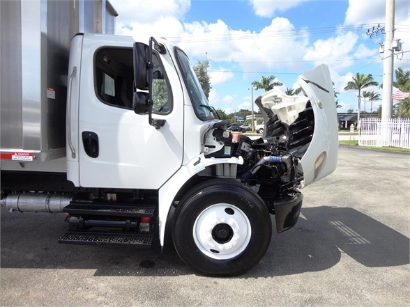 Front-left angle of a 2014 Freightliner Business Class M2 106 with the hood open, showing engine bay and front wheel.