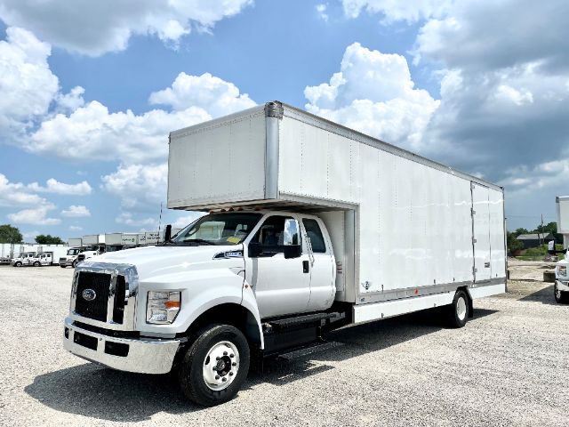 Ford F-650 moving van truck showing side profile with box cargo area and cab.