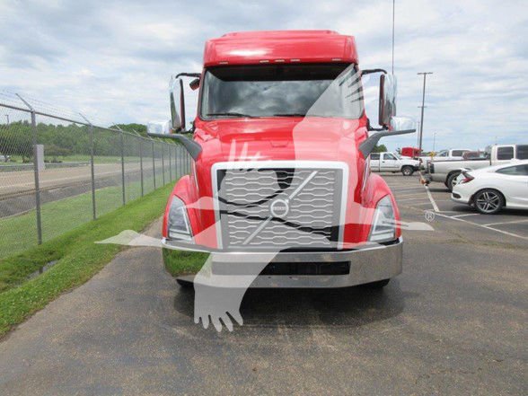 Volvo VNL64T740 front view showing large chrome grille, headlights, and red cab with watermark/overlay text.