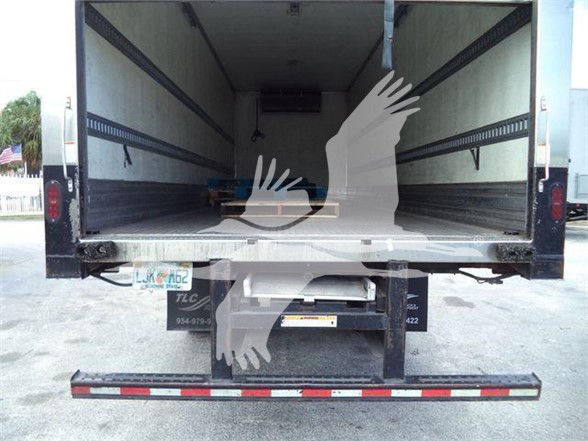 Truck reefer with open cargo area showing empty trailer interior and rear doors.