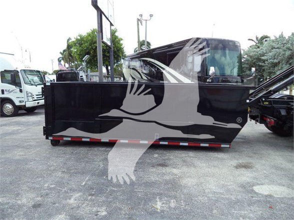 Truck bed side panel of a Freightliner Business Class M2 106 with a black finish in a lot. Watermark of a dove image overlay.