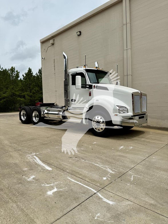 Kenworth T880 conventional daycab trucks front three-quarter view showing white cab and chrome exhaust stacks.