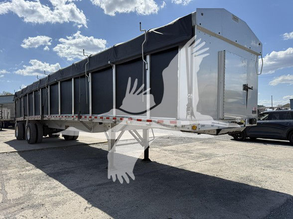 2022 Reitnouer Big Bubba flatbed trailer with covered cargo area and landing gear, side view showing dual rear axles.