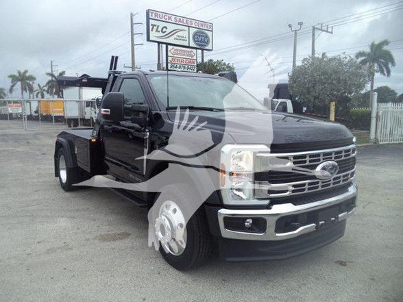 2024 Ford F-450 tow-truck style dual-wheel front view showing chrome grille, black body, and towing equipment.