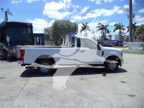 2017 Ford F250 pickup truck in a dealership lot, side view, white with long bed.