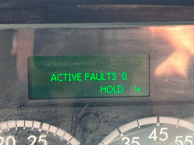 Vehicle dashboard display showing 'ACTIVE FAULTS 0' and 'HOLD' with a green backlit screen.