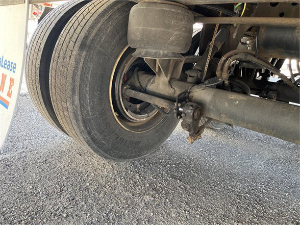 Trailer axle and dual tires of an 2018 Vanguard dry van showing rear suspension components and wheel hub.