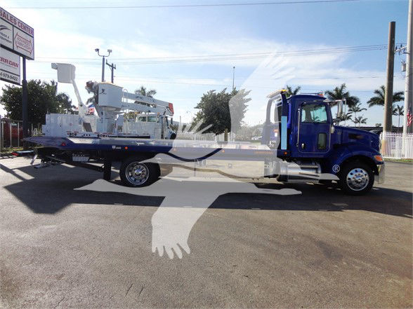 2022 Peterbilt 337 tow truck with long flatbed, blue cab, rear lift equipment visible