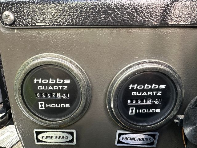 Two Hobbs quartz gauges in a vehicle dashboard cluster showing pump hours and engine hours; left gauge shows 03523 hours, right gauge shows 85515 hours.