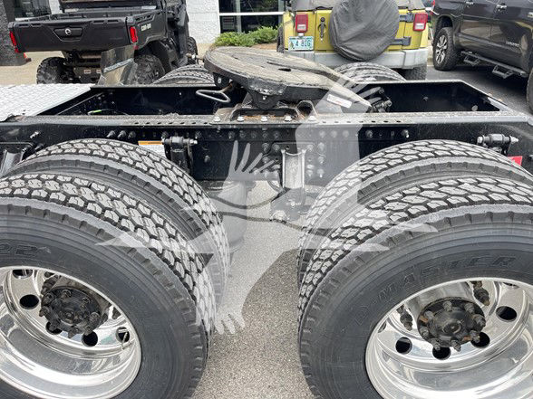 Volvo truck chassis showing double rear axles and dual wheels, with suspension and frame components visible