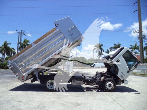 Isuzu NQR dump truck with tilted dump bed and front cab visible in side view.