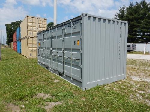 20' open side shipping container in a yard with other containers in the background.