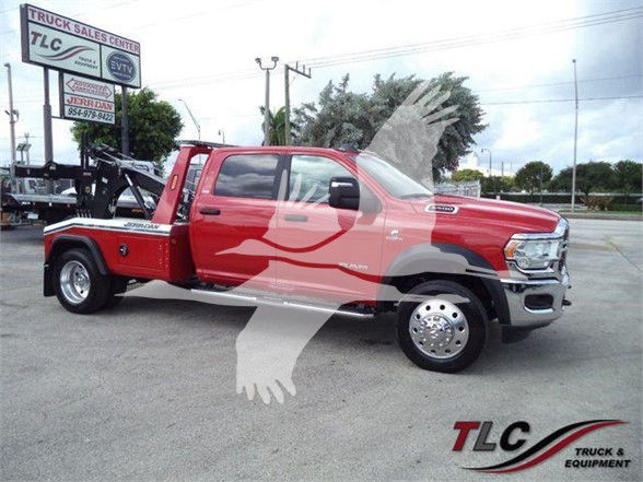 Ram 5500 tow truck red crew cab with flatbed, side view, TCL Truck & Equipment watermark.
