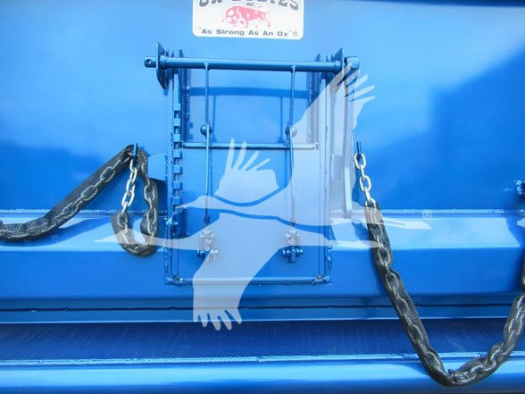 Kenworth T380 dump truck stakegate area with blue paint and chain tie-downs.