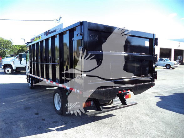 Isuzu NRR dump truck rear and side view, black dump body with graphic reflection, dual rear lights, tailgate and rear bumper visible.