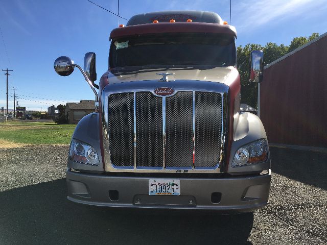 Peterbilt 578 front view showing chrome grille, headlights, bumper, and California license plate on a sleeper truck