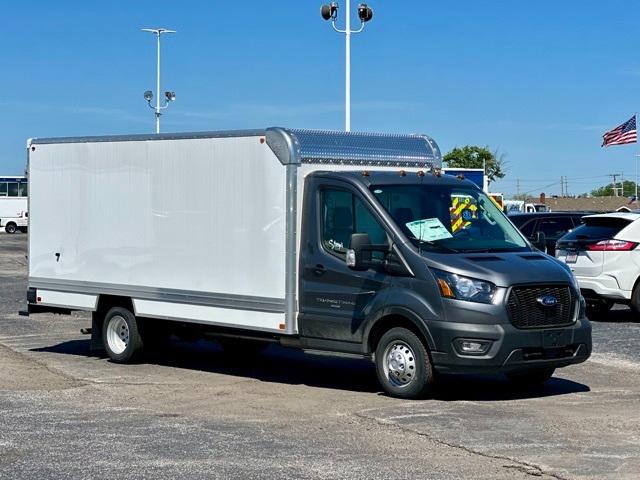 Ford Transit 350 box truck in grey chassis with white box, 16' box, front view slightly angled showing cab, cargo area, and aluminum diamond-plate hood guard.