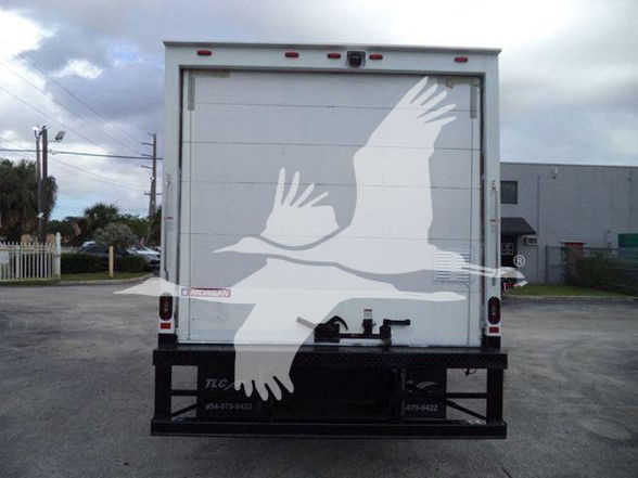 Isuzu NPR HD box truck rear view with white cargo doors and black steel bumper.