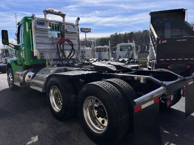 2018 Peterbilt 579 daycab tractor rear view showing chassis, dual rear axles, large tires, and metal steps.
