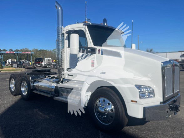 Kenworth T880 conventional daycab tractor in white, front three-quarter view, chrome exhaust stacks, dual rear axles, shiny wheels, large grille.