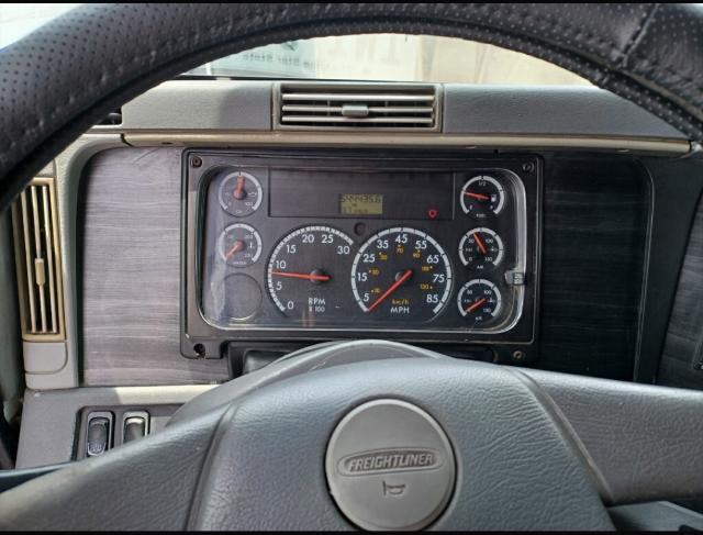 Dashboard of a 2007 Freightliner Columbia truck showing instrument cluster with RPM, speed, and gauges in view from the driver’s seat.