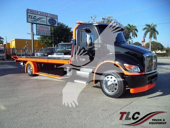 Kenworth T280 tow truck with flatbed, black cab, orange accents, stock number EDGEDSTEPSIDE visible at a TLC Truck & Equipment lot.