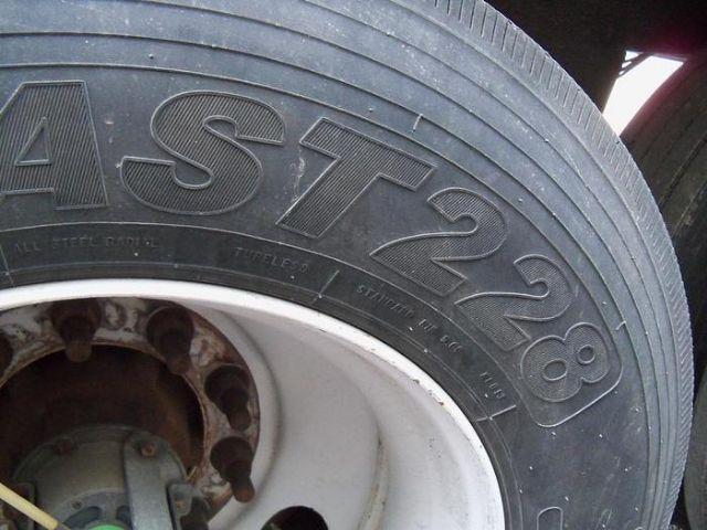 Close-up of a tire showing the sidewall text 'AST22' and wheel hub.