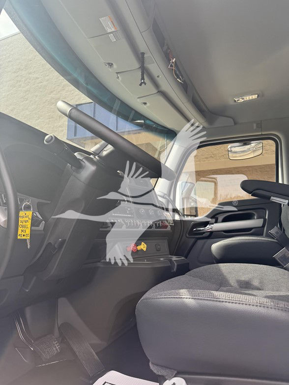 Kenworth T880 truck interior cab dashboard and steering wheel view from passenger side with seat and controls visible.