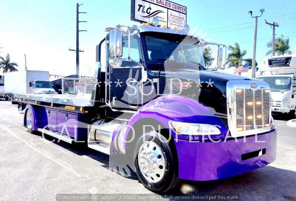 Peterbilt 337 tow truck with purple front fenders and chrome grille, stock number J62703, display shows SOLD watermark and CALIFORNIA DREAM label.