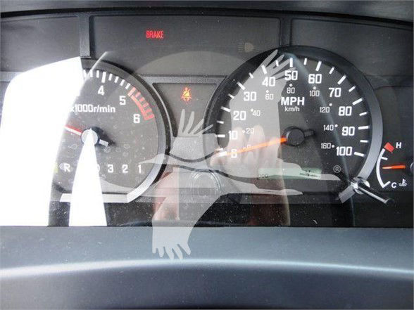 Isuzu NRR instrument cluster showing tachometer and speedometer with warning lights illuminated.