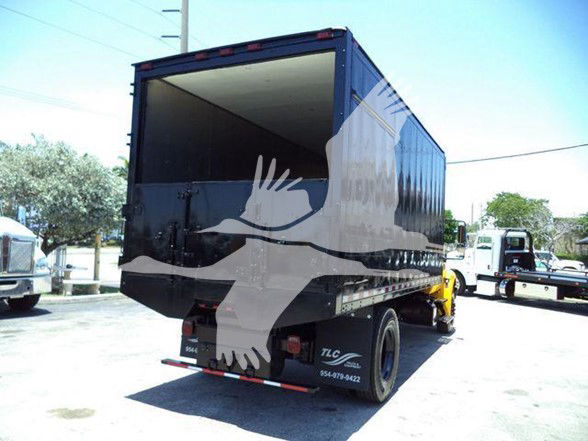 Truck rear/side view showing cargo bed and International DURASTAR 4300 chassis, with open cargo area. Visible text may include vehicle features but legible text is not clear.