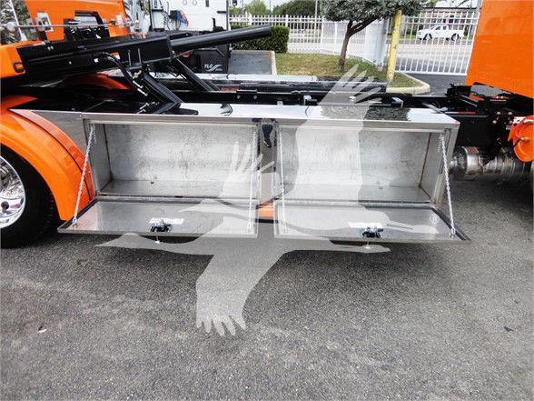 Peterbilt 337 truck bed with two open toolbox compartments under the cab, metal silver finish, storage drawers exposed.