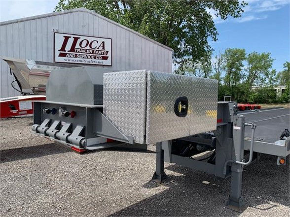 Container delivery trailer with tanem axle showing front toolbox and diamond plate storage.