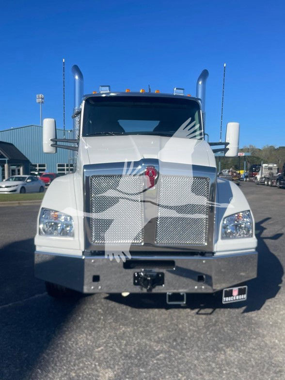 Kenworth T880 conventional daycab front view showing chrome grille, large bumper, dual exhaust stacks, and rectangular headlights.