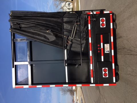 Great Dane single drop trailer rear view showing black tarpaulin cover and red/white reflective striping.