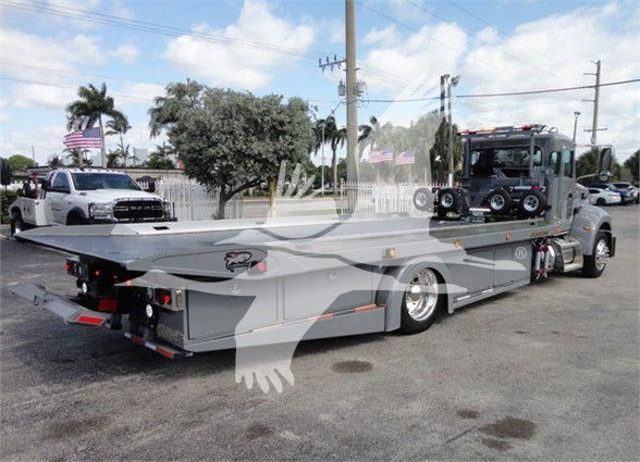 2022 Peterbilt 337 tow truck with flatbed, side view showing vehicle and equipment, VIN sticker not clearly legible, no visible fluid labels.