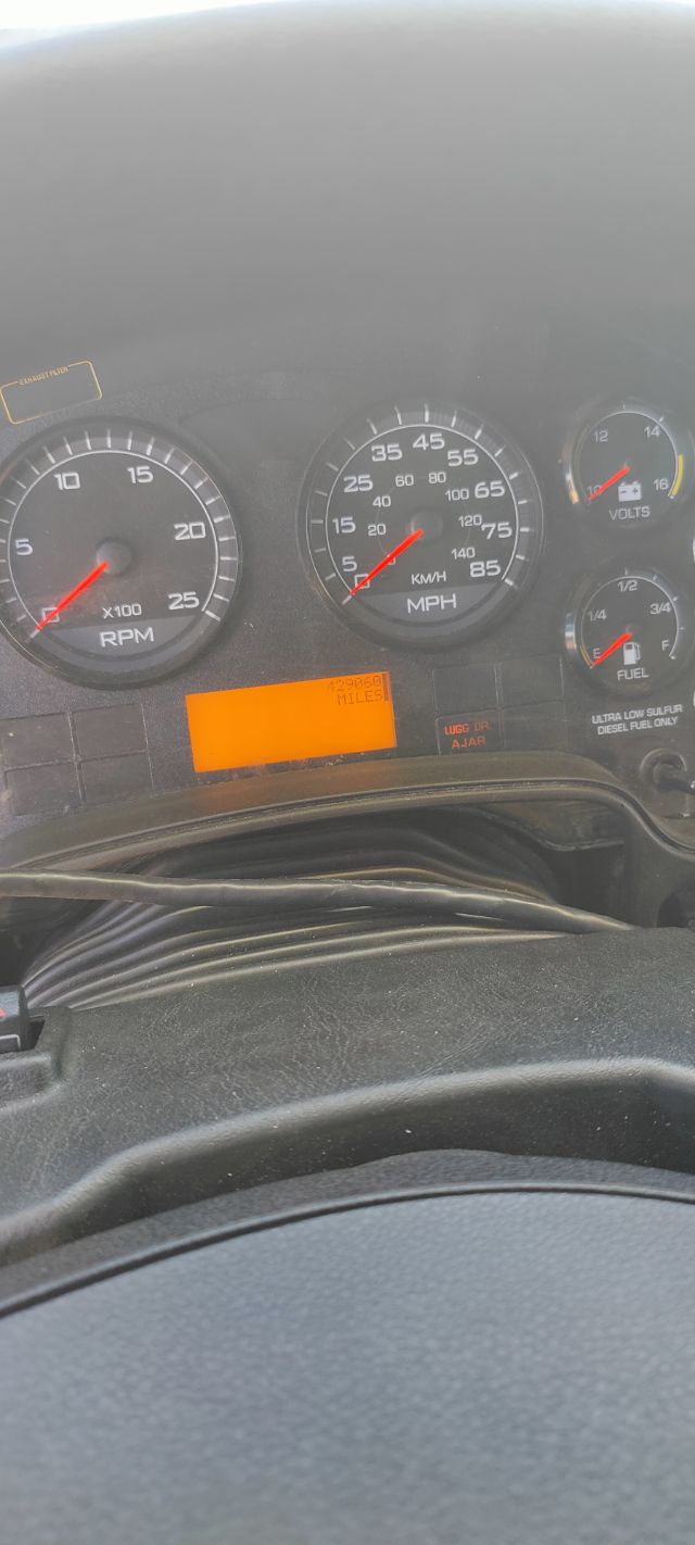 Dashboard of a 2016 International ProStar showing tachometer, speedometer, volt gauge, fuel gauge, and an orange digital odometer display reading miles.