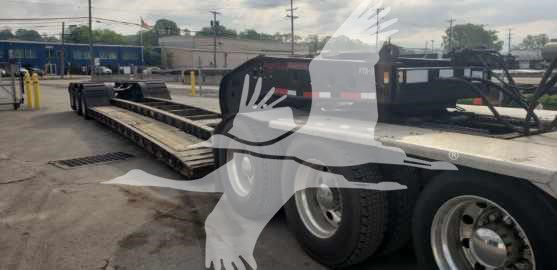 Trailer showing a Fontaine 55 Ton drop side rail lowboy with dual rear axles and long flatbed, VIN plate and stock number in view.