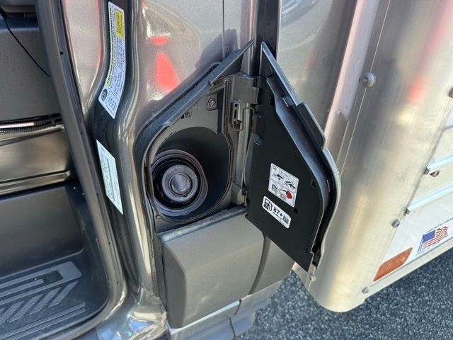 Ford Transit 350 box truck entry with open fuel cap area and lower step. Visible labels on door and hinge area.