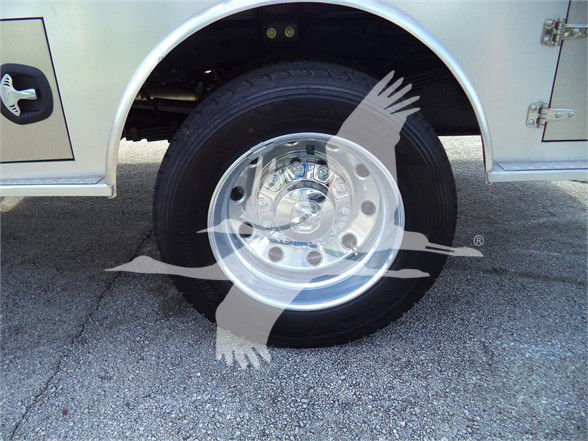 Wheel and tire on a Ram 5500 truck, chrome hubcap with visible lug nuts and black tire.