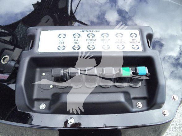 Truck control panel with multiple labeled levers and colored pins; labels include TILT and BOOM with icons.