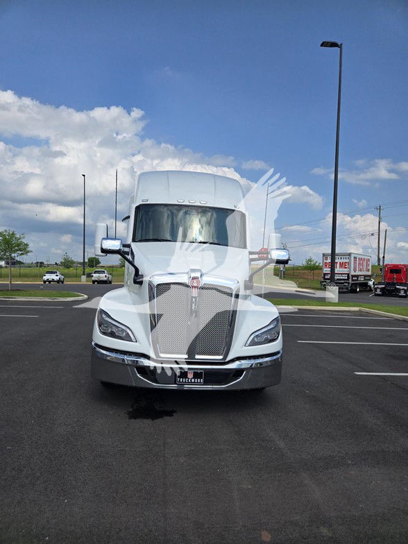 Kenworth T680 truck front view in a parking lot showing grille, headlights, and side mirrors.
