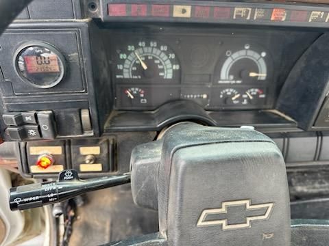 Dashboard of a Chevrolet Kodiak truck showing gauges and steering wheel with Chevrolet logo.