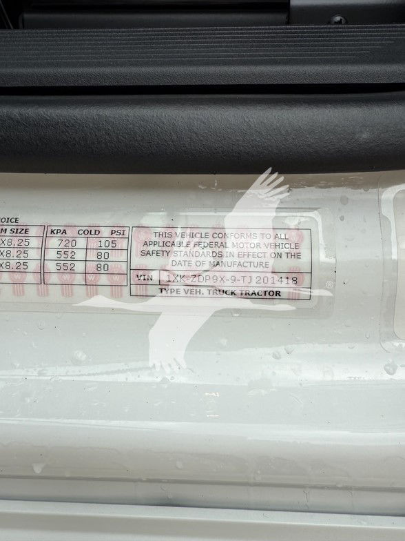 Kenworth T880 engine bay label showing VIN 1XKZDP9X9TJ201418 and standard truck tractor specifications.