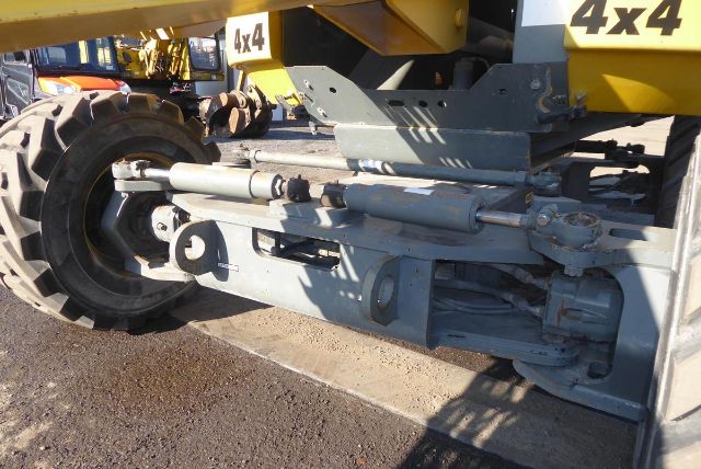Industrial vehicle hydraulic components and suspension on a Grove T60 boom lift with 4x4 markings.