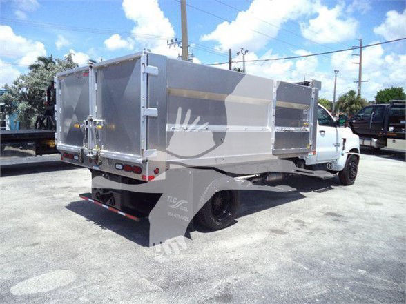 A 2023 Chevrolet Silverado 6500HD dump truck with aluminum dump bed. Side and rear doors visible; dual rear lights; rear bumper and mud flaps. Brand logos not fully legible.