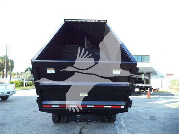 Rear view of a Freightliner M2 106 dump truck bed with tailgate and bumper lights.