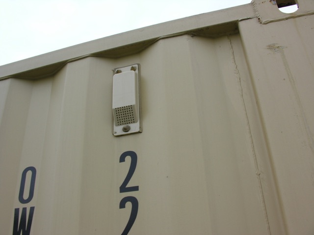 Trailer container side with a small vent or exhaust and the numbers '02' visible, part of a shipping container or trailer.
