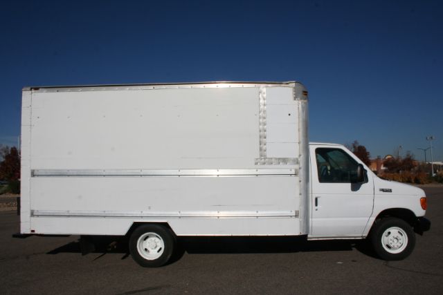 2005 Ford E350 white moving box truck side view showing cargo box and cab.