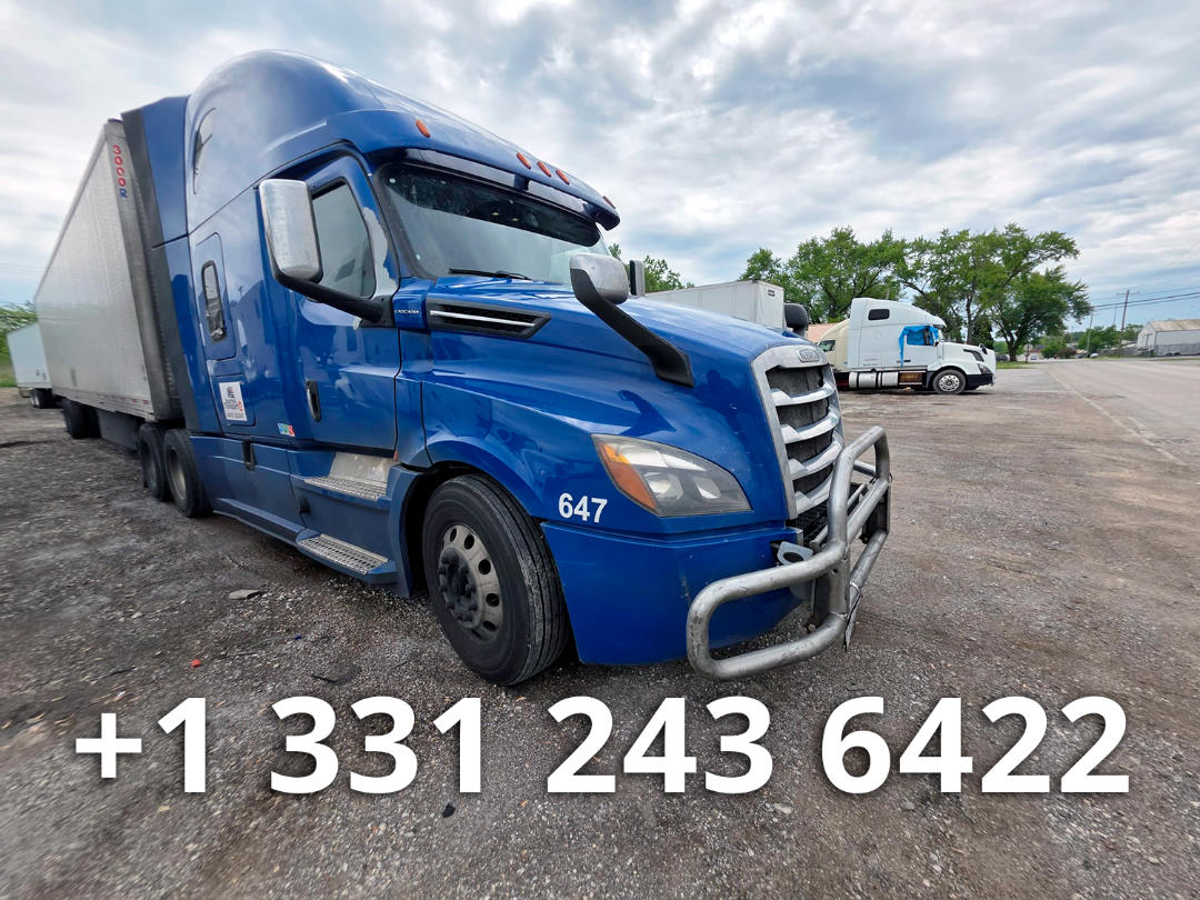 Blue Freightliner Cascadia truck with sleeper cab and chrome bull bar, 647 white numeral on front fender, attached trailer, gravel lot, large phone number overlay.